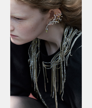 woman with red hair wearing jewellery