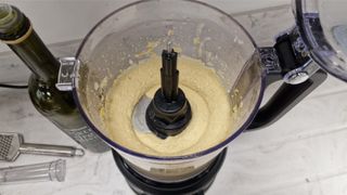 The KitchenAid 9-Cup Food Processor open with blended hummus inside