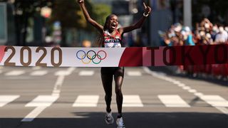 Kenya's Peres Jepchirchir crosses the finish with arms outstretched after winning the women's marathon at Tokyo 2020.