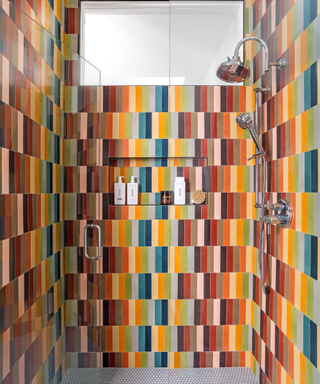 Multicolored tile shower enclosure with pops of teal, coral, orange, red, and green