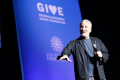 Jon Stewart speaks on stage at The New York Comedy Festival and The Bob Woodruff Foundation present the 12th Annual Stand Up For Heroes event at The Hulu Theater at Madison Square Garden on N