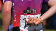 Image of gels and ride food in the jersey pockets of an SD Worx rider