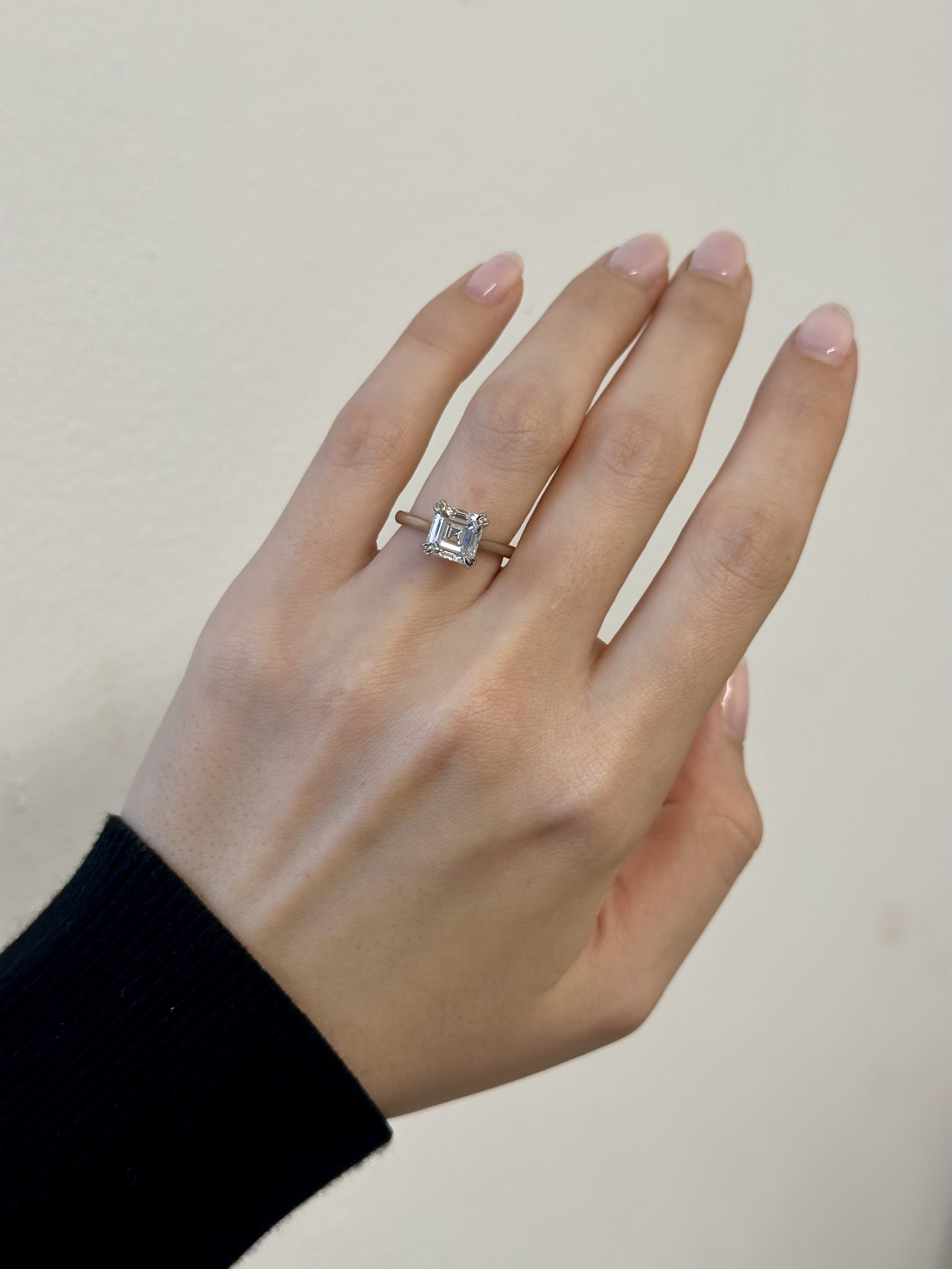 Woman wearing engagement ring on finger.