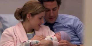 Jim and Pam with their first child in The Office.