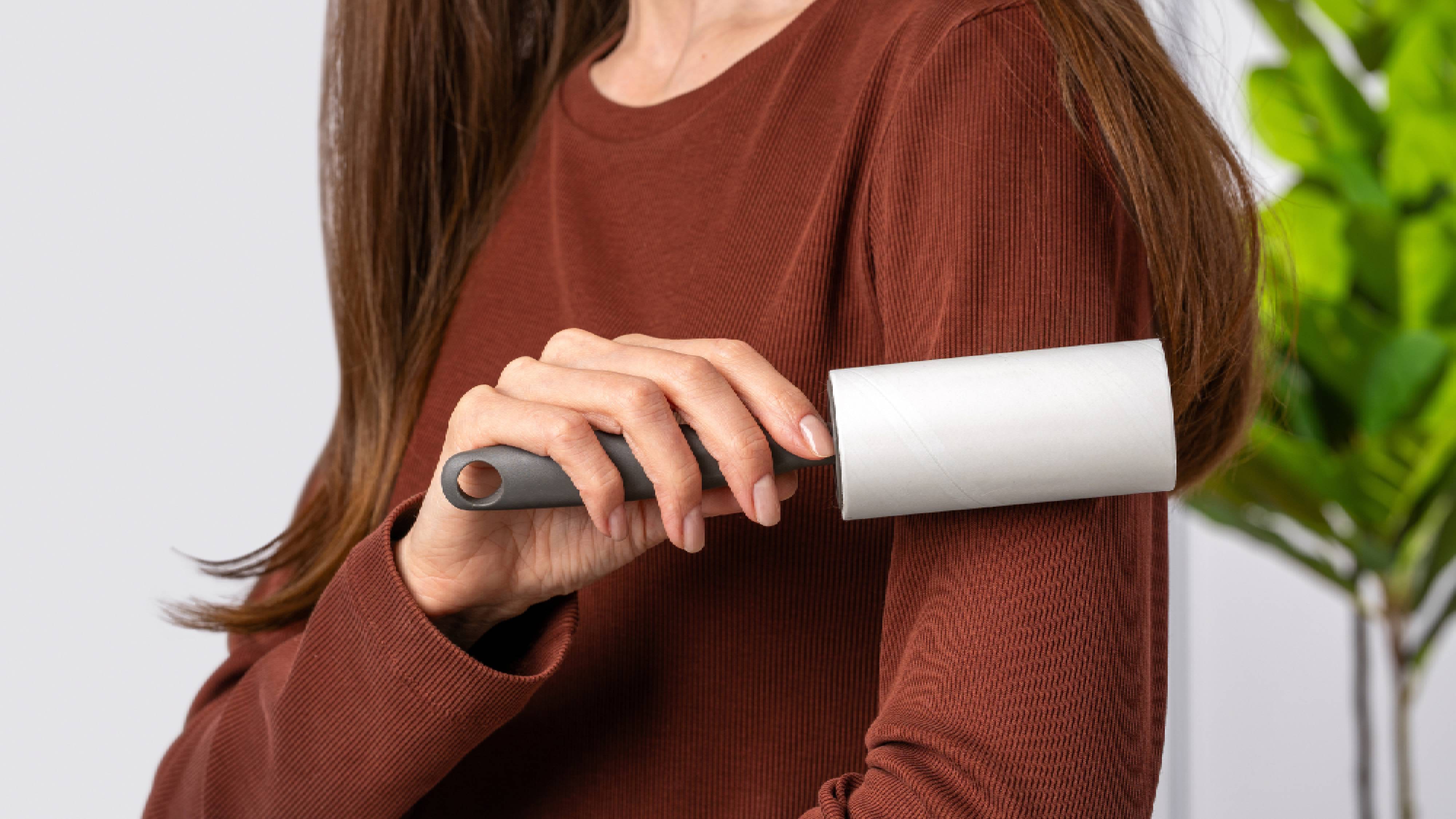 Woman using lint roller