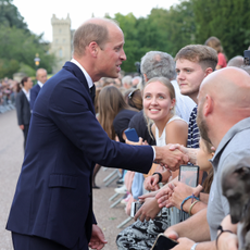 Prince William, Prince of Wales shakes hands with members of the public on the Long walk at Windsor Castle on September 10, 2022 in Windsor, England. Crowds have gathered and tributes left at the gates of Windsor Castle to Queen Elizabeth II, who died at Balmoral Castle on 8 September, 2022.