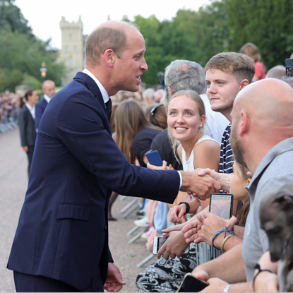 Prince William, Prince of Wales shakes hands with members of the public on the Long walk at Windsor Castle on September 10, 2022 in Windsor, England. Crowds have gathered and tributes left at the gates of Windsor Castle to Queen Elizabeth II, who died at Balmoral Castle on 8 September, 2022.