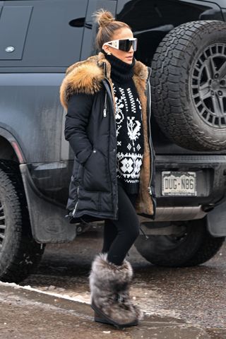 Jennifer Lopez is seen on December 27, 2024 in Aspen, Colorado wearing yeti boots and a navy blue parka with a fair isle sweater