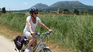A woman exploring Catalonia on her bike her