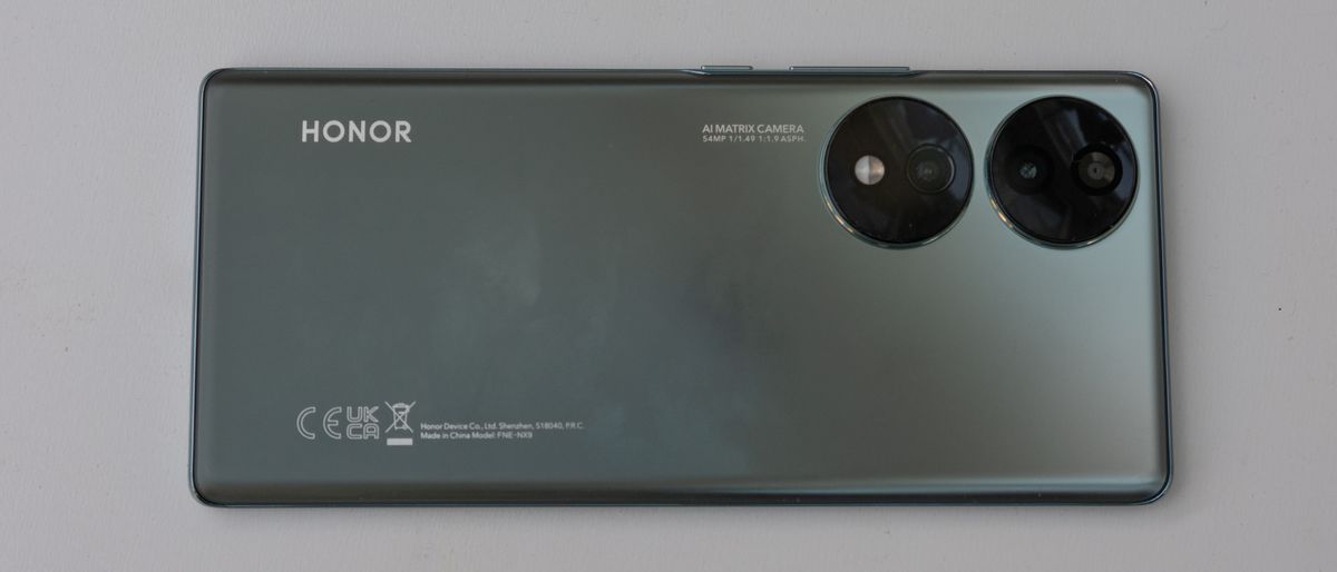 A metallic green Honor 70 smartphone on a table