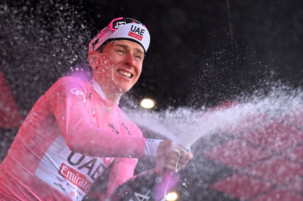 DESENZANO DEL GARDA ITALY MAY 18 Tadej Pogacar of Slovenia and UAE Team Emirates celebrates at podium as Pink Leader Jersey winner during the 107th Giro dItalia 2024 Stage 14 a 312km individual time trial stage from Castiglione delle Stiviere to Desenzano del Garda UCIWT on May 18 2024 in Desenzano del Garda Italy Photo by Tim de WaeleGetty Images