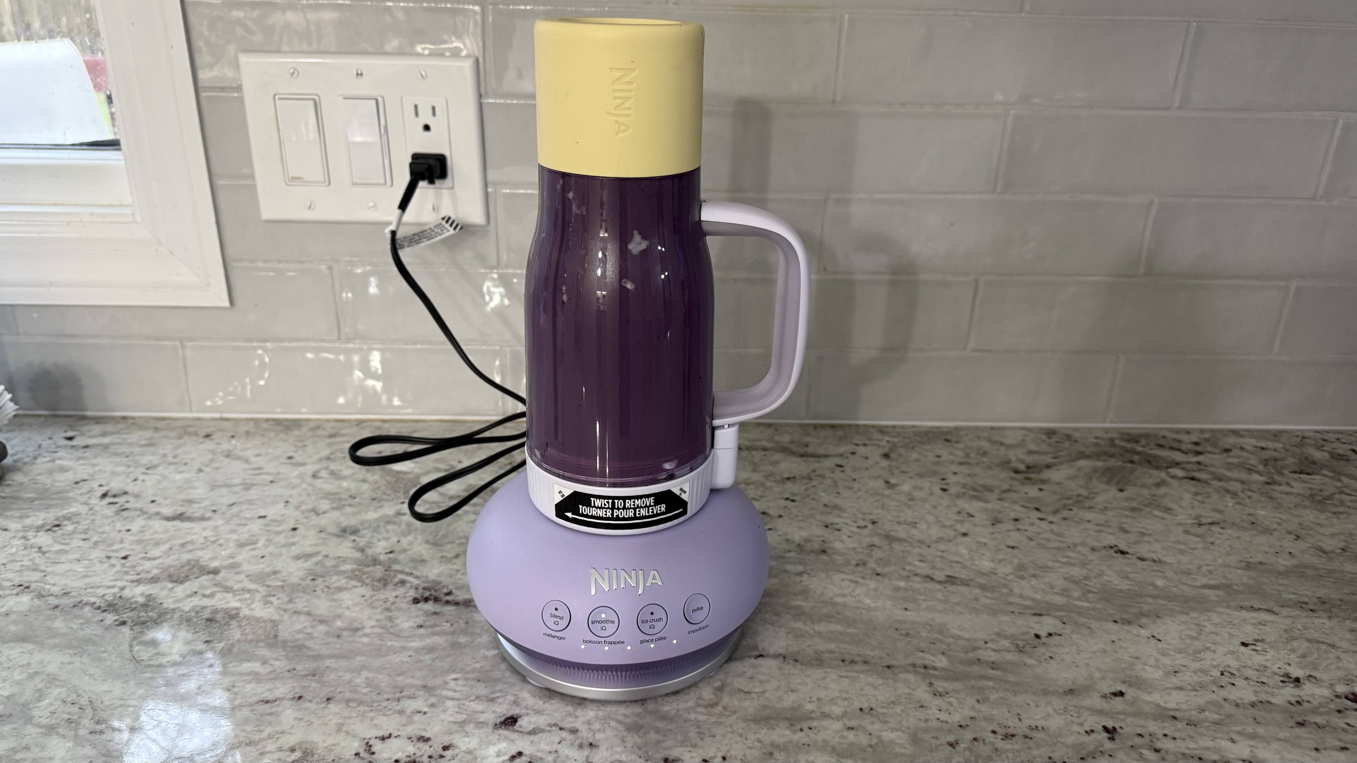 Ninja BlendBOSS&trade; Tumbler Blender with 26oz Travel Tumbler making banana, blueberry, and spinach smoothie