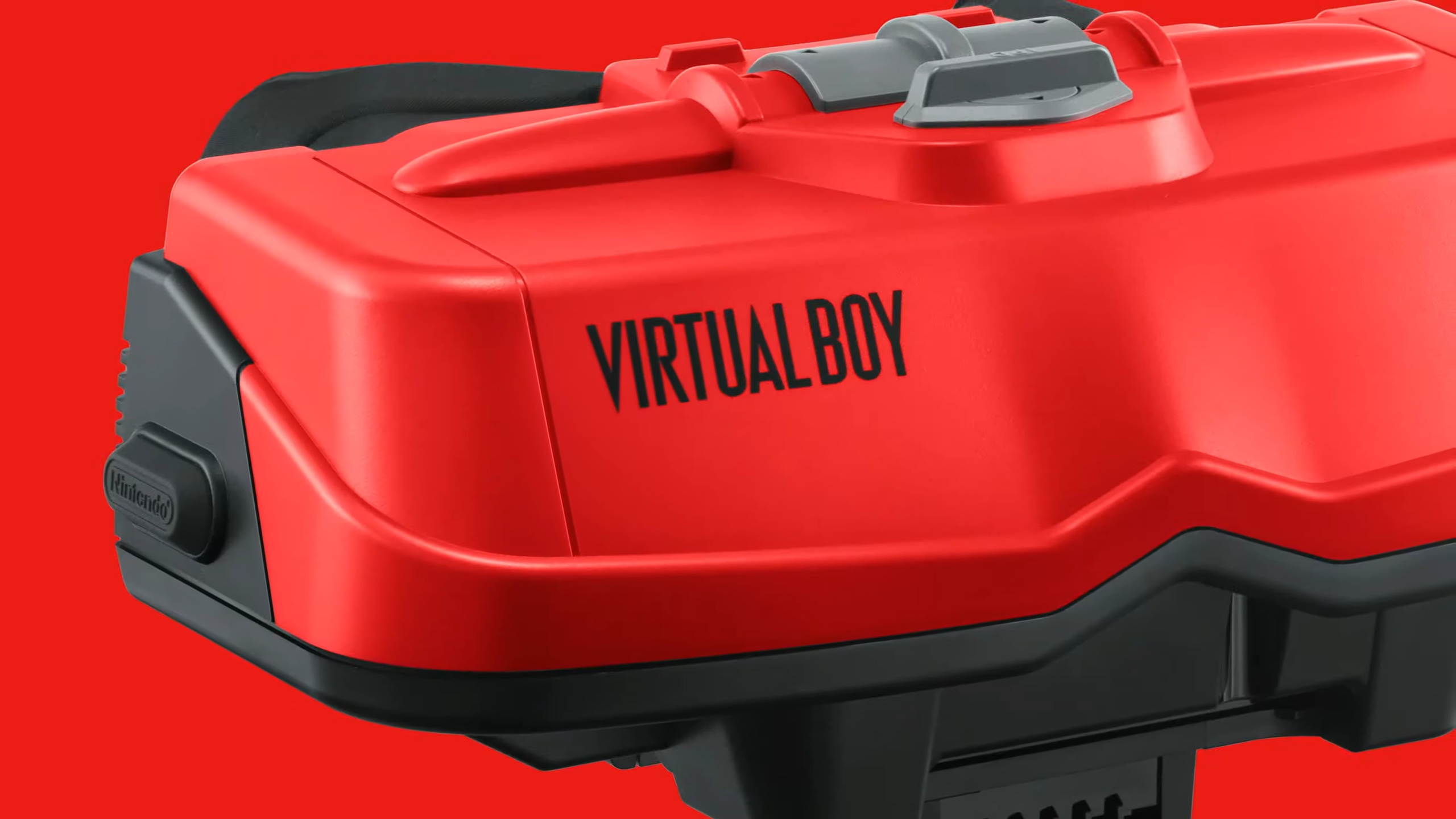 Close up of Virtual Boy logo on accessory with red backdrop