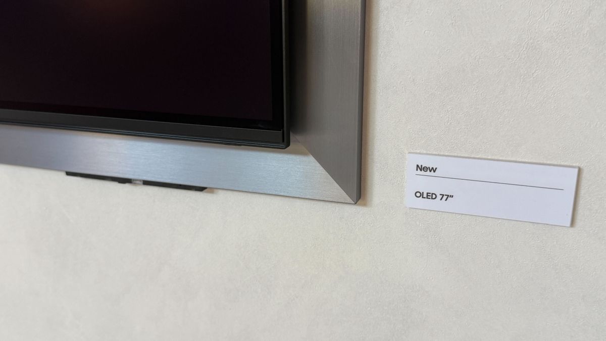 A wall mounted Samsung S95H showing stock footage of Las Vegas at night time