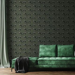 room with animal print wall and green sofa