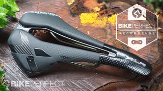 A top-down view of the black Selle Italia X-LR TI316 Superflow saddle, with central cut-out, black X on the right flank and shiny gloss finish on the nose