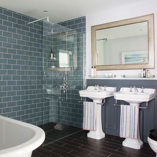 white ceramic sink near white ceramic bathtub