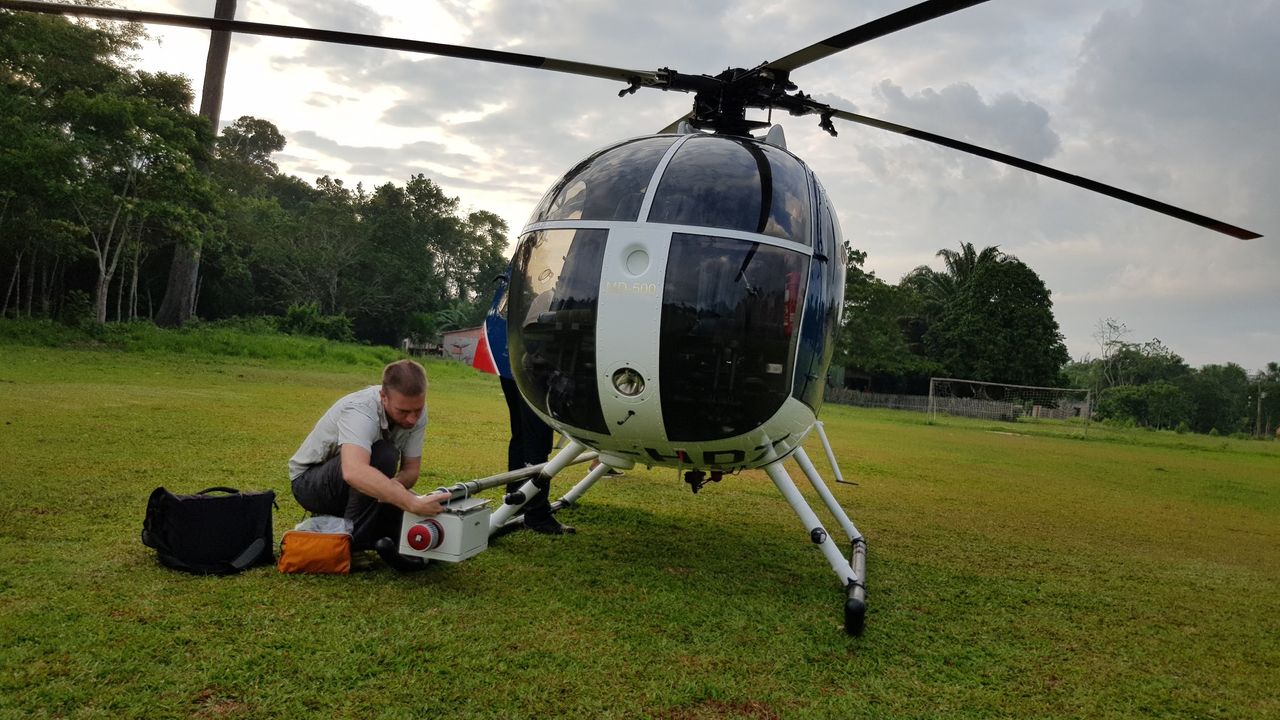 Study co-researcher Mark Robinson mounts the lidar sensor to the helicopter.