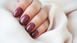 A hand with mauve nail polish