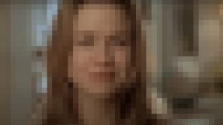 Renee Zellweger stands crying in her doorway in Jerry Maguire, pixelated.