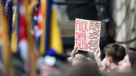 Anti-Royalists hold up a placard in protest at King Charles' Proclamation ceremony in Edinburgh