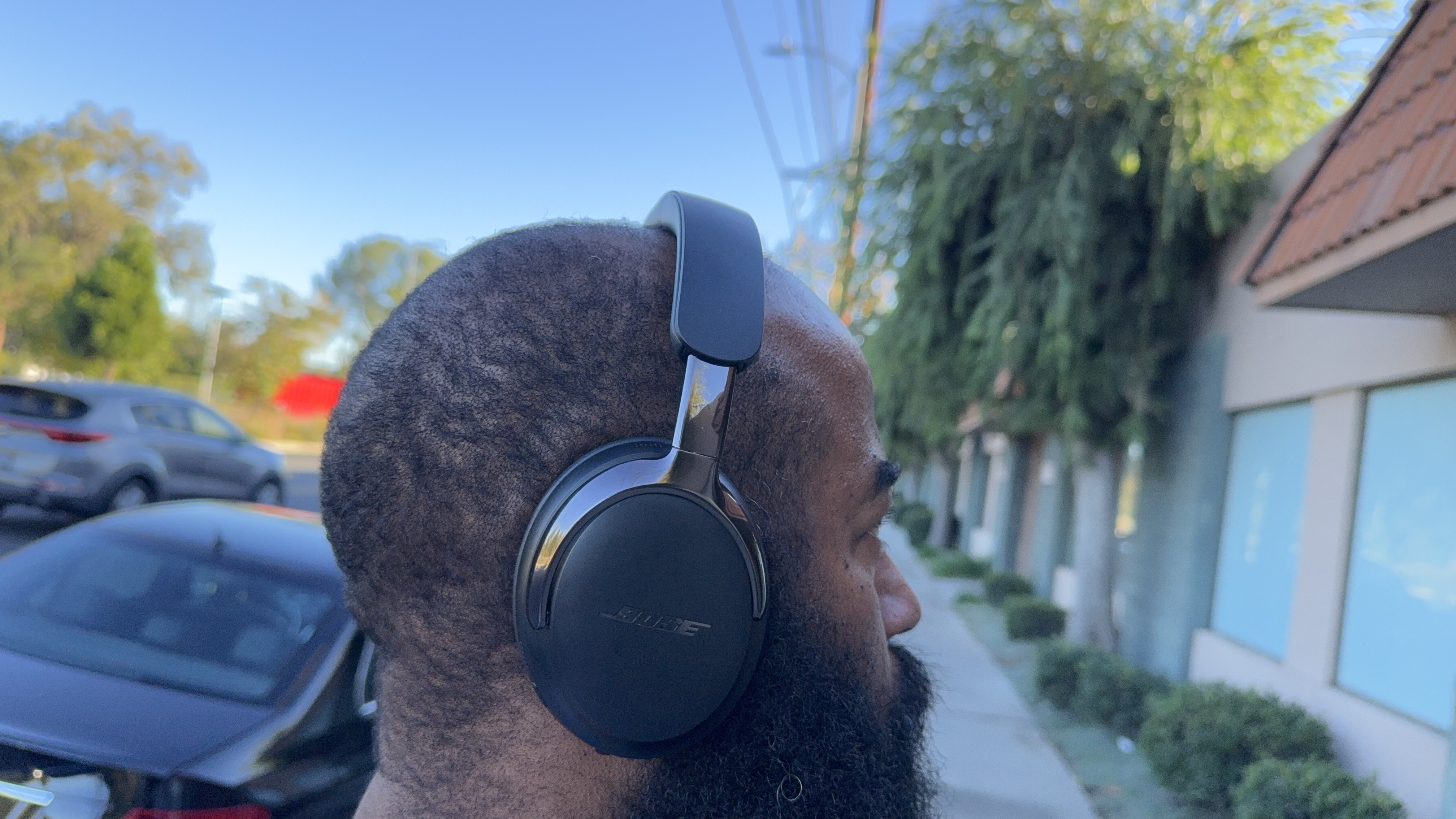 Bose QuietComfort Ultra Headphones (2nd Gen) being worn by reviewer, testing the ANC on a busy street