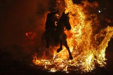 A man rides a horse through a bonfire as part of a ritual in honor of Saint Anthony the Abbot, the patron saint of domestic animals, in San Bartolome de Pinares, Spain.