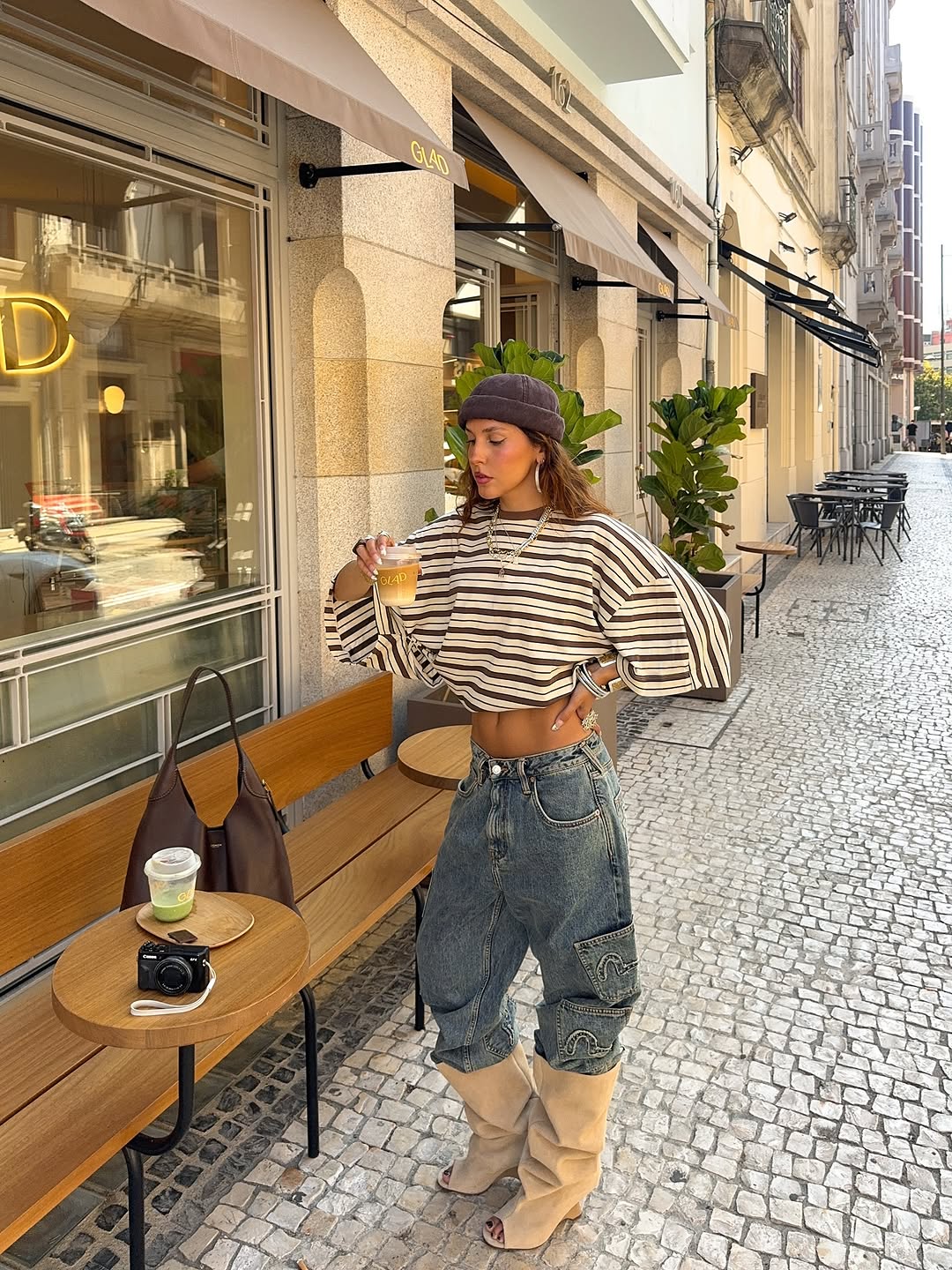 Woman wearing boots tucked into jeans trend fall 2025.