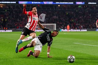 EINDHOVEN, NETHERLANDS - MARCH 4: Richard Ledezma of PSV battles for possession with Myles Lewis-Skelly of Arsenal FC during the UEFA Champions League 2024/25 Round of 16 First Leg match between PSV and Arsenal FC at PSV Stadion on March 4, 2025 in Eindhoven, Netherlands. (Photo by Ben Gal/BSR Agency\Getty Images)