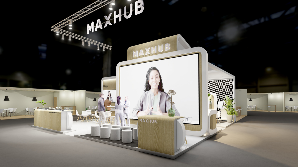 MAXHUB&#039;s trade show stand with huge displays in mock conference rooms showing videoconferencing solutions. 