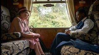Penelope Wilton and David Jonsson riding on a train in Agatha Christie's Murder is Easy