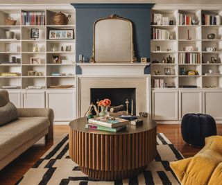 living room with remodeled fireplace and alcove shelving