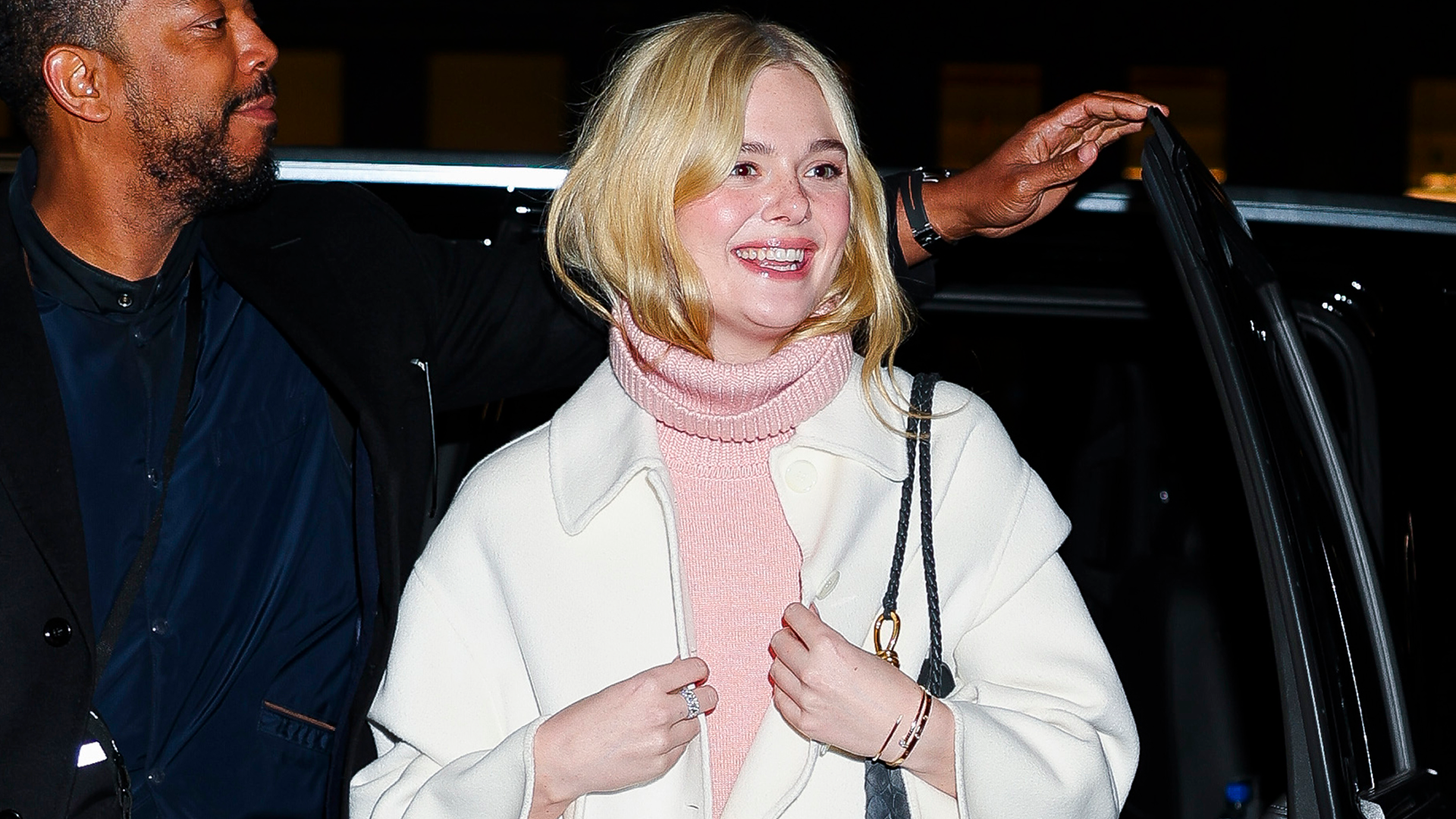 Elle Fanning was spotted in NYC wearing a turtleneck take on the dress over pants trend