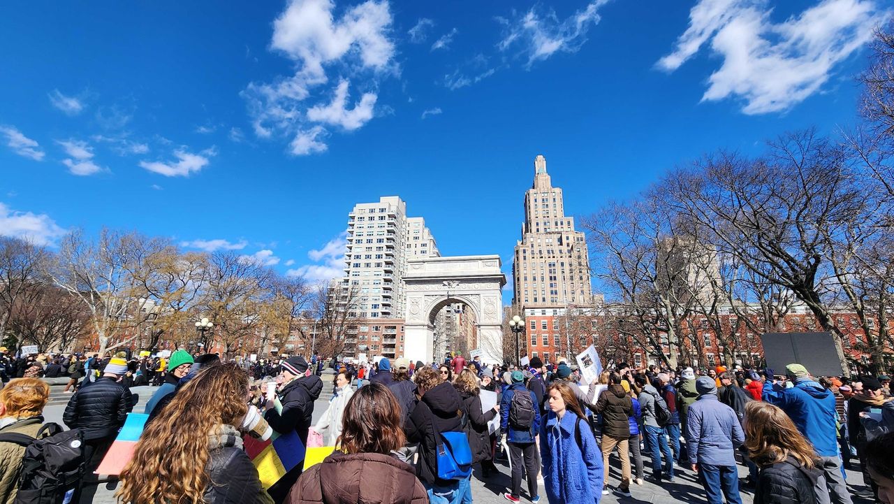 A large group of people marches in the city at the Stand up for Science rally