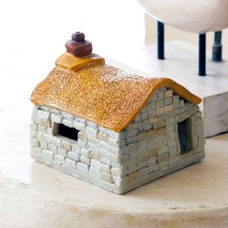 white brick wall toy house with yellow roof