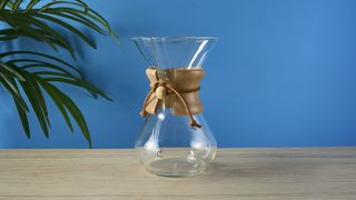 an hourglass coffee maker by Chemex with a 6 cup capacity and a wooden collar with a rawhide tie