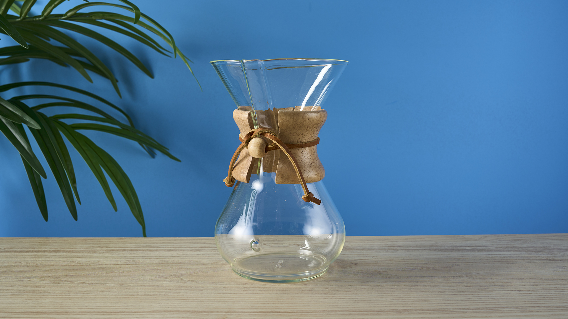 a 6-cup hourglass coffee maker from Chemex and a wooden collar with a rawhide tie