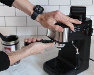 Camryn Rabideau putting portafilter into Mr. Coffee Steam espreso machine