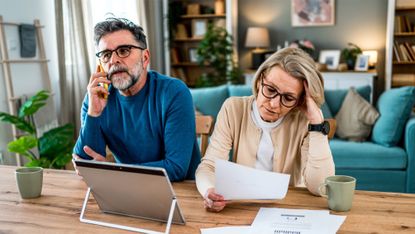 Mature couple stressed about finances and bills