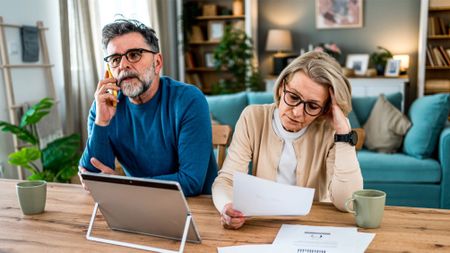 Mature couple stressed about finances and bills