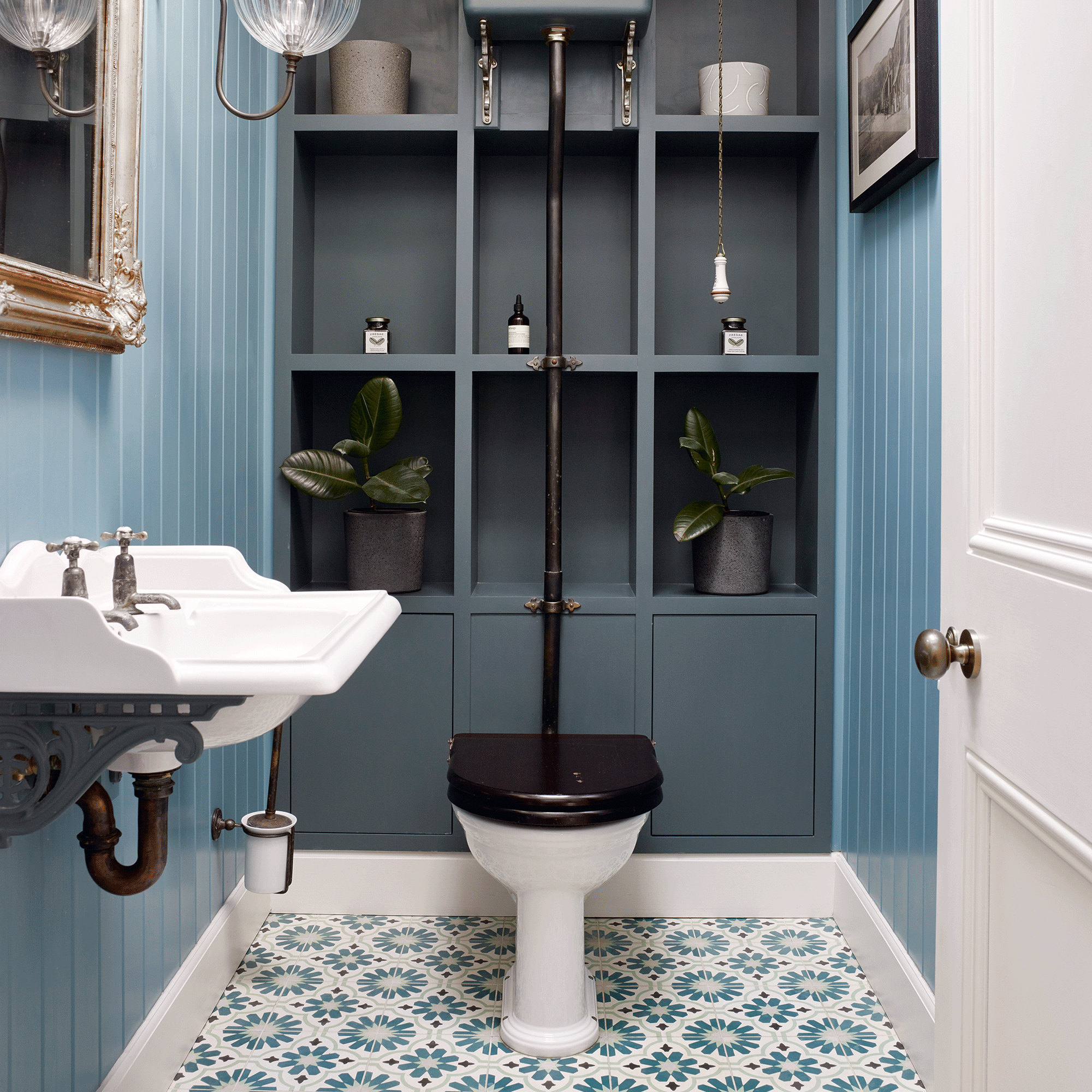 Blue bathroom with storage and black toilet seat