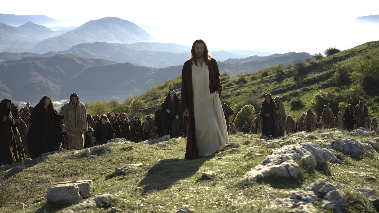Jesus standing on rocky hill as many followers stand behind him in The Resurrection of The Christ Part 1
