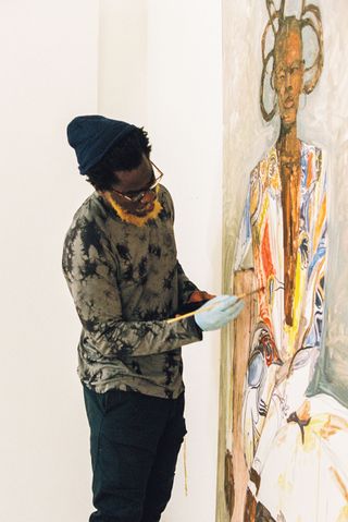 Portrait of Serge Attukwei Clottey working on a new painting.