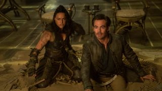 Holga (Michelle Rodriguez) and Edgin (Chris Pine) on their knees in Dungeons and Dragons: Honor Among Thieves