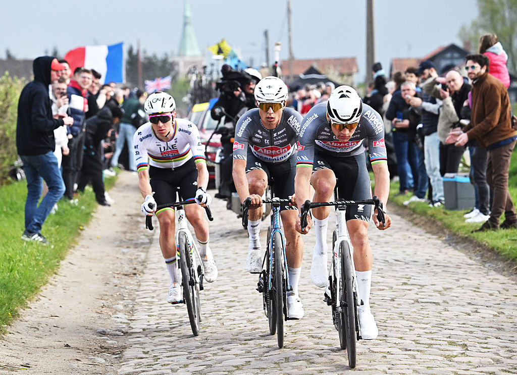 ROUBAIX, FRANCE - APRIL 13: (L-R) Tadej Pogacar of Slovenia and UAE Team Emirates - XRG, Jasper Philipsen of Belgium and Mathieu Van Der Poel of Netherlands and Team Alpecin - Deceuninck compete in the breakaway passing through a cobblestones sector during the 122nd Paris - Roubaix 2025 a 259.2km one day race from Compiegne to Roubaix / #UCIWT / on April 13, 2025 in Roubaix, France. (Photo by Bernard Papon - Pool/Getty Images)