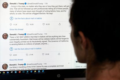A person looks at Trump's tweets on a computer screen.
