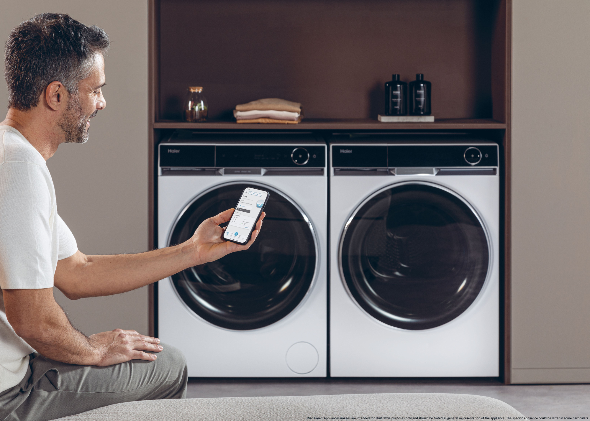 A man using an app to operate his washer and dryer