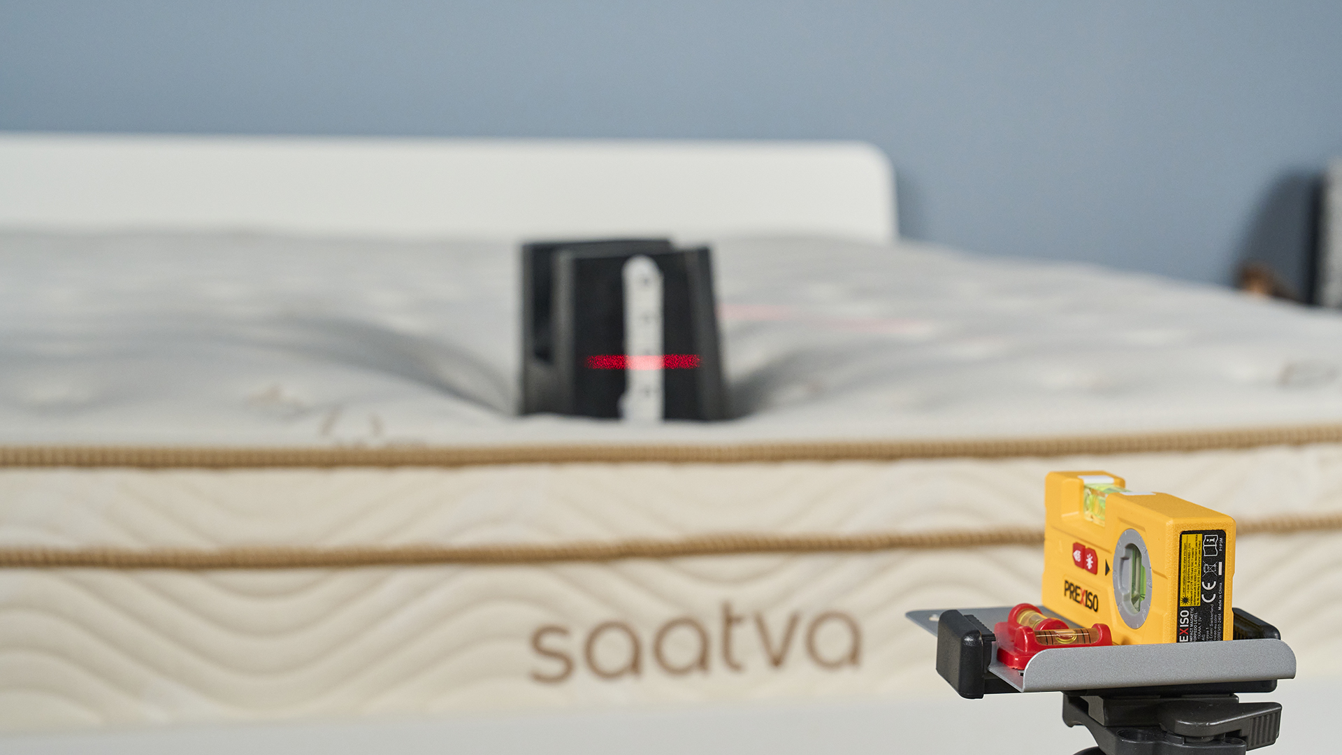 Edge support test using a cast iron 25kg weight on foot of the Saatva Classic mattress