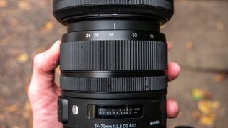 Person selecting a focal length of 35mm on a lens