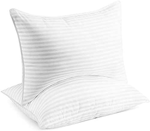 The best thin pillows of 2022 include the Beckham Hotel Collection Pillows, pictured as a pair on a white background.